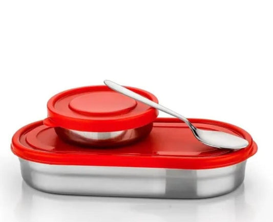 Red oval steel lunch box with round bowl and spoon on white