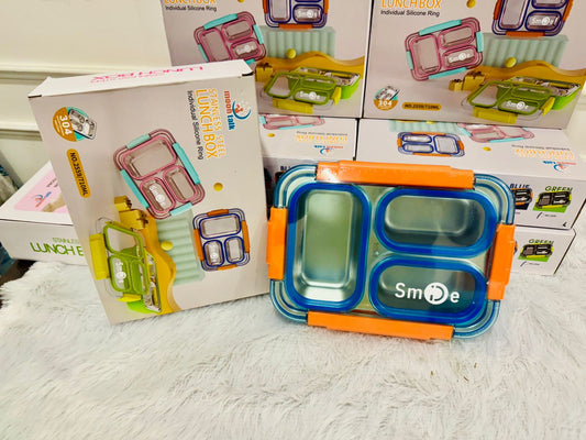 Blue three compartment steel lunch box in front of its packaging