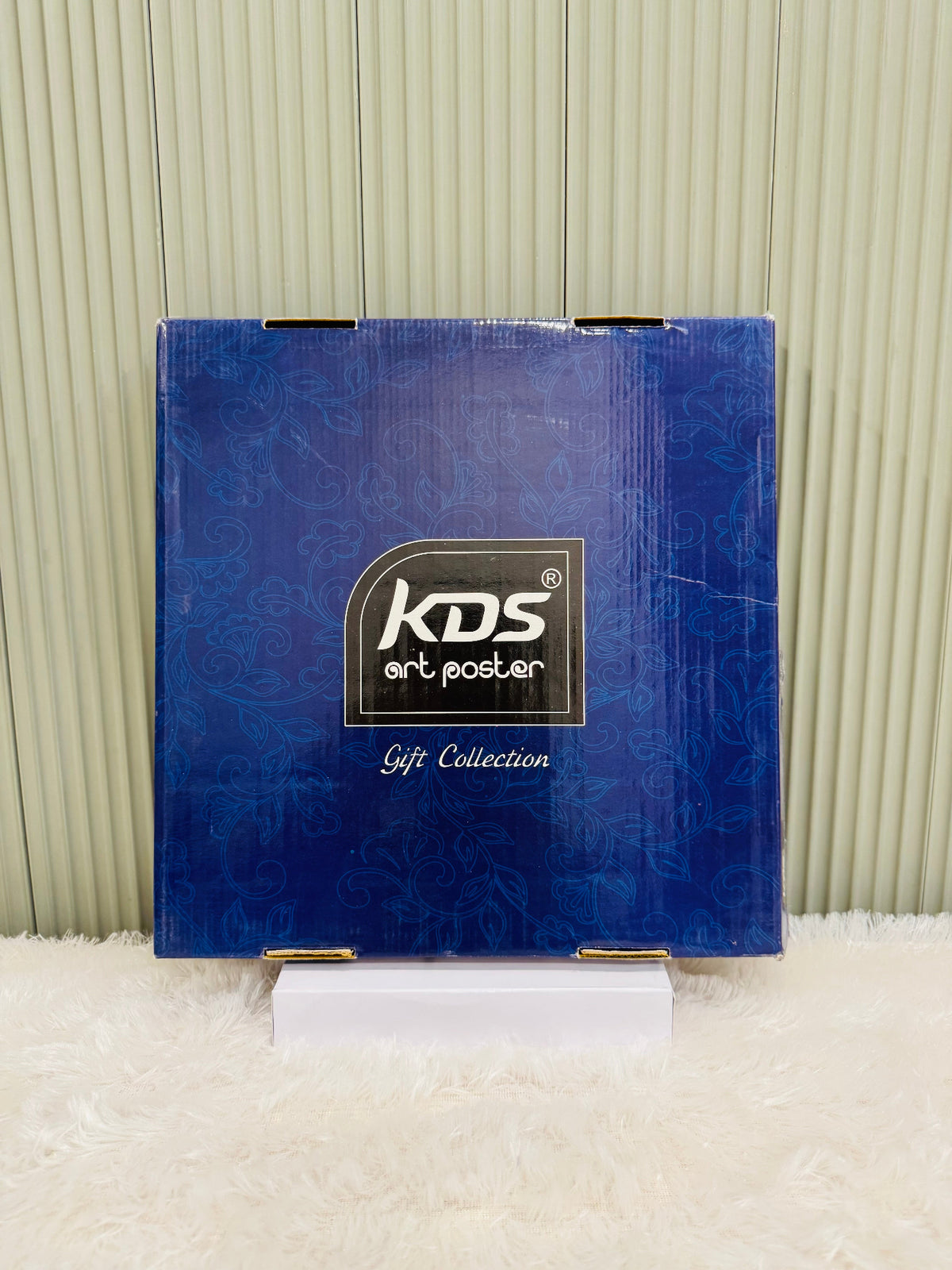 Closed blue KDS gift collection box for the framed wall painting