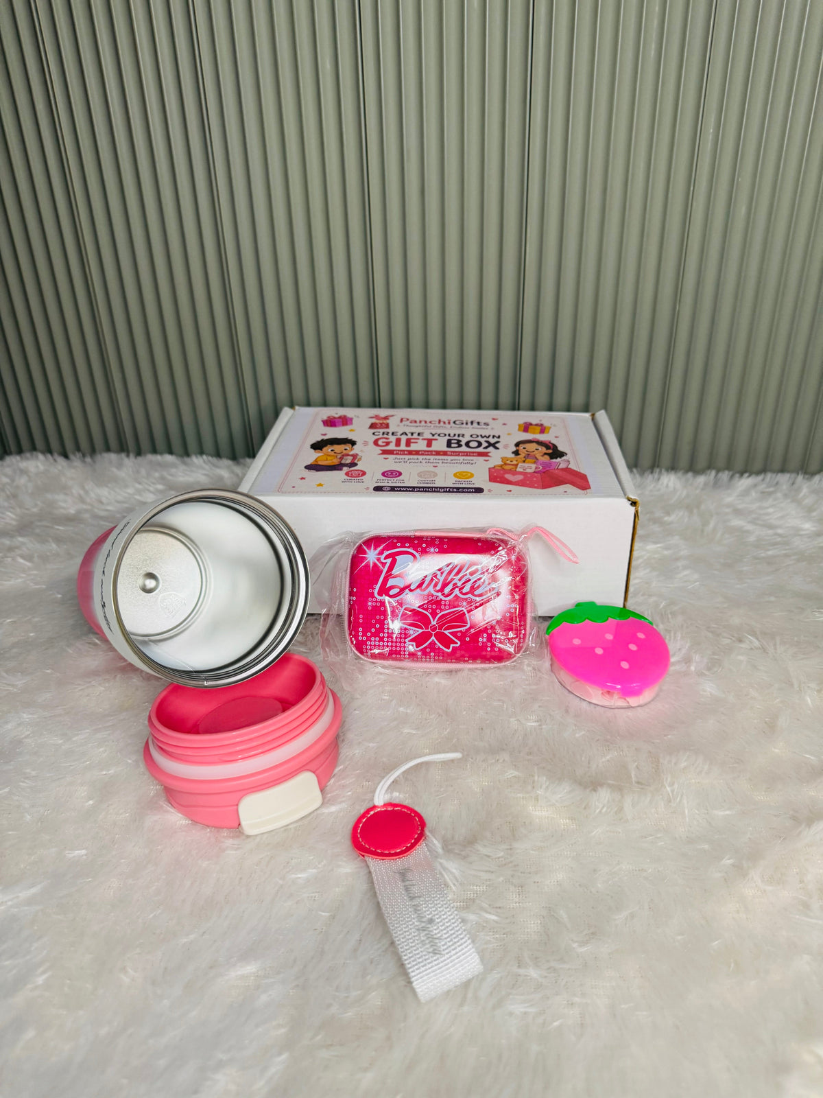 Disassembled pink travel mug showing stainless steel interior and lid parts