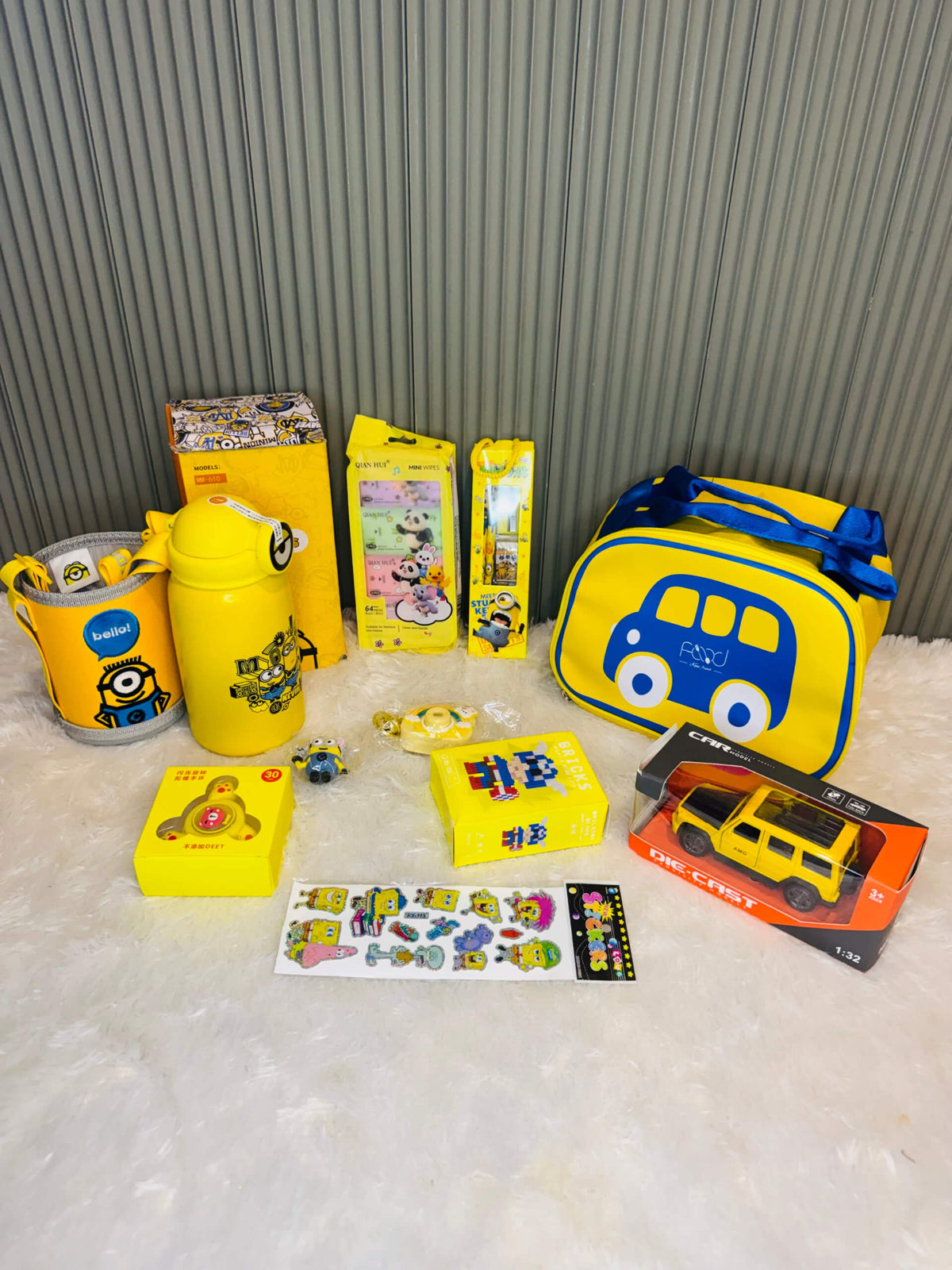 Full yellow theme hamper spread with bottle, lunch bag, car, bricks and stickers