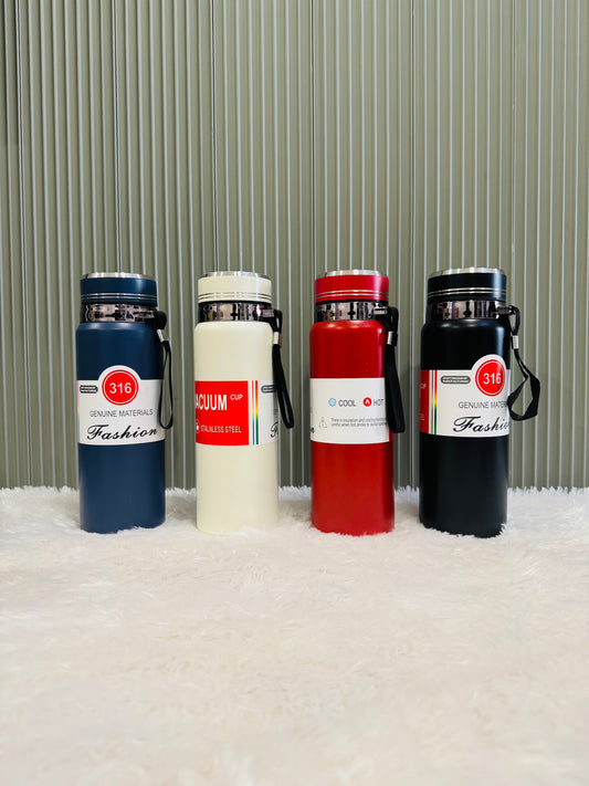 Four 800ml vacuum bottles in navy, cream, red and black on a rug