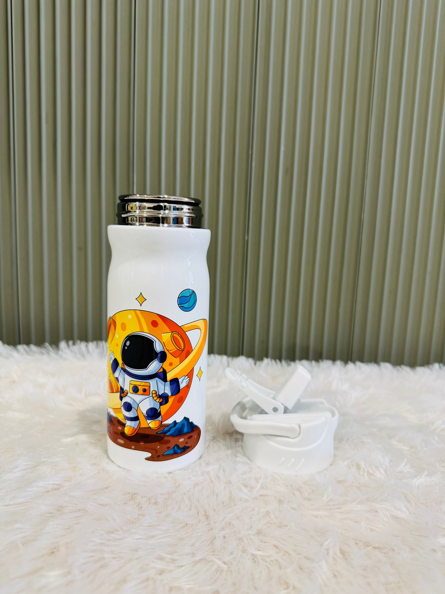 White 400ml bottle with astronaut print beside its white flip lid
