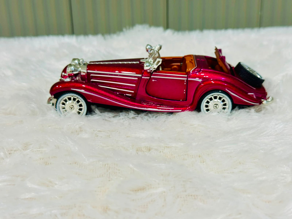 Red vintage die cast toy car with chrome trim, side view