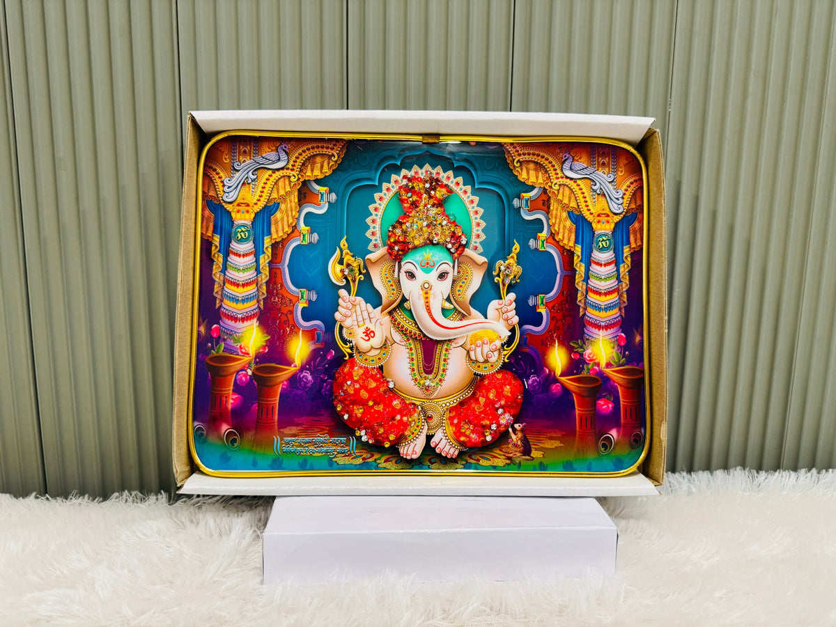 Crystal embedded Ganesha wall painting on a stand against a panel wall