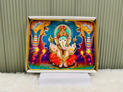 Crystal embedded Ganesha wall painting on a stand against a panel wall