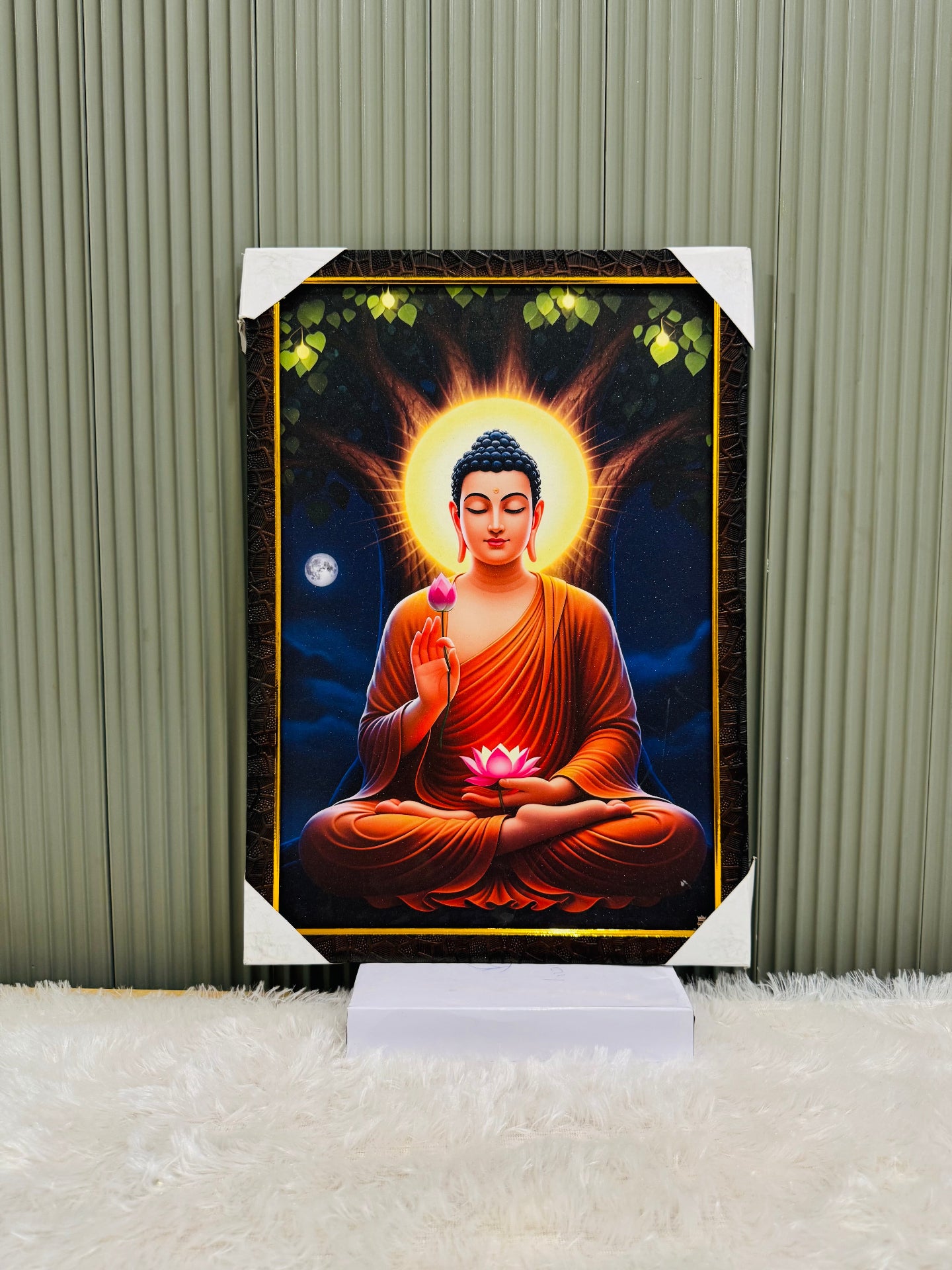 Golden framed Buddha wall painting with a glowing halo on a stand