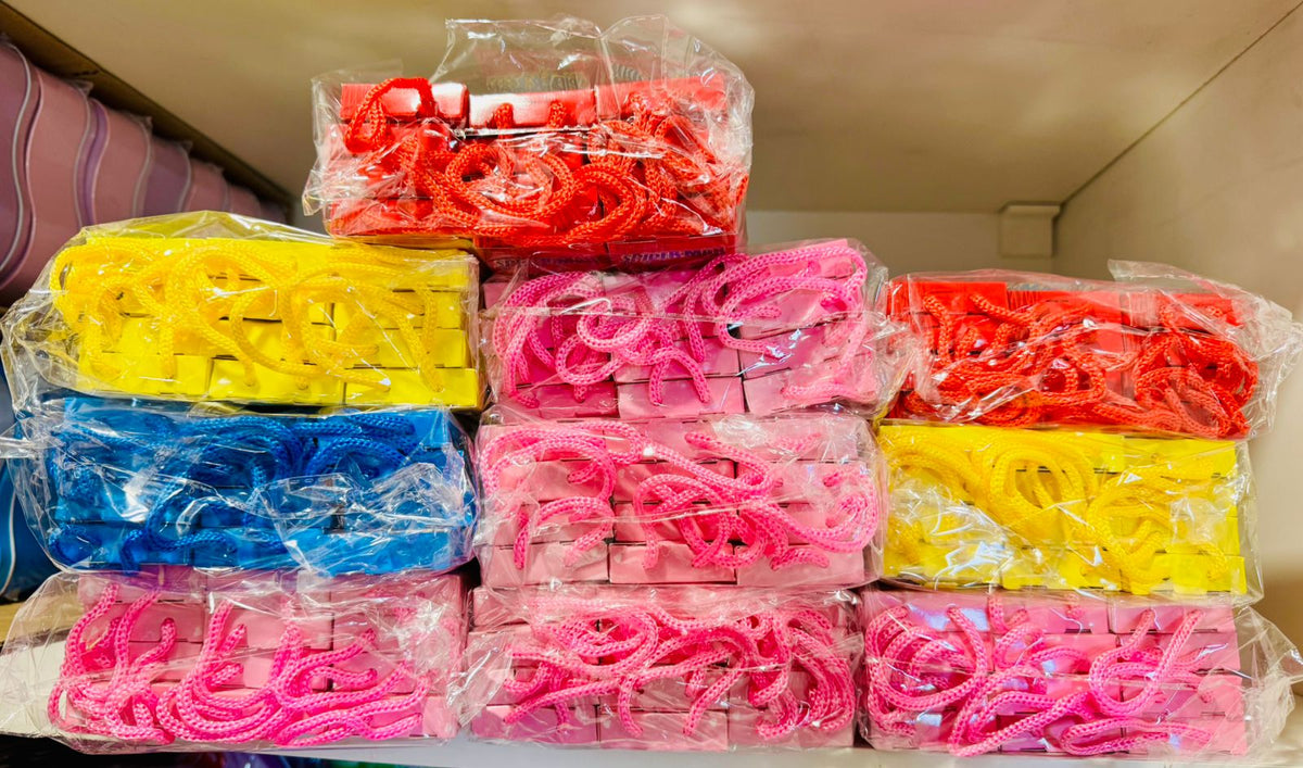 Bulk stack of packaged stationery gift sets with rope handles