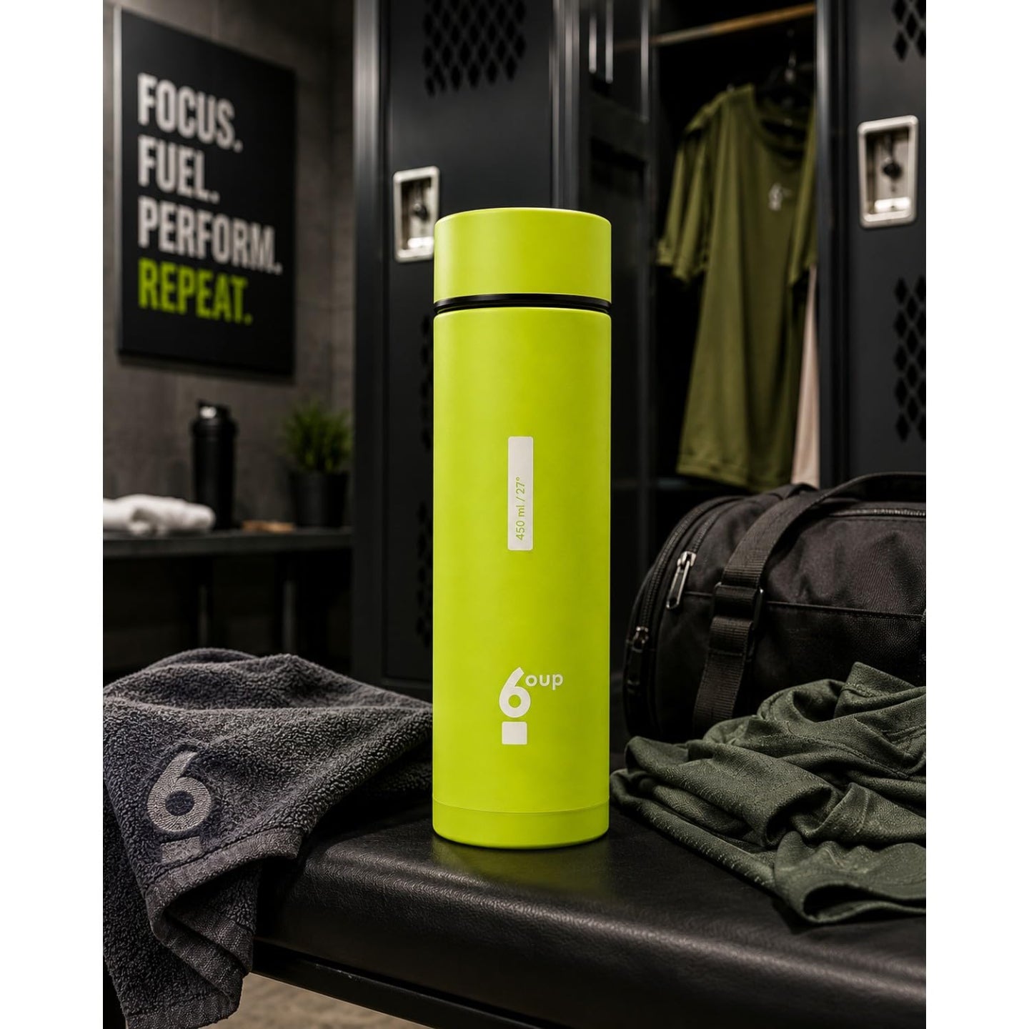 Green 6oup glass bottle on a gym bench in a locker room setting