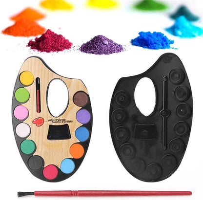 Watercolour palette with brush beside its black moulded tray insert