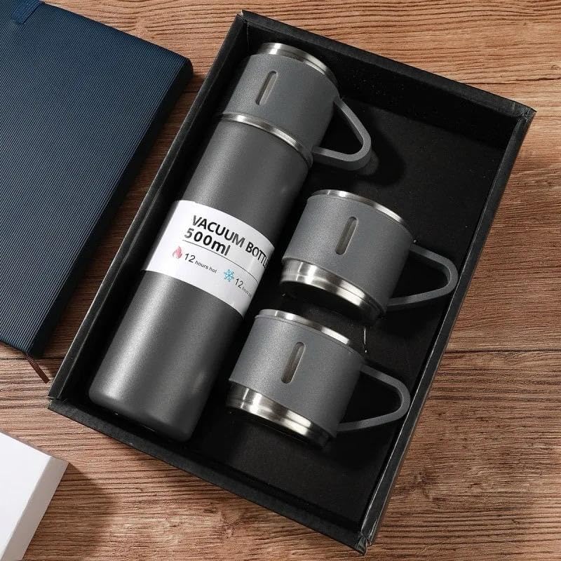 Grey vacuum flask and two cups presented in an open gift box
