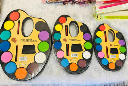 Three large oval watercolour artist palettes with twelve pans and brushes