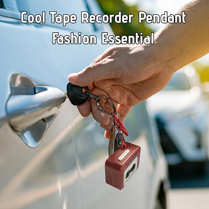 Hand holding car keys with a red tape recorder keychain attached
