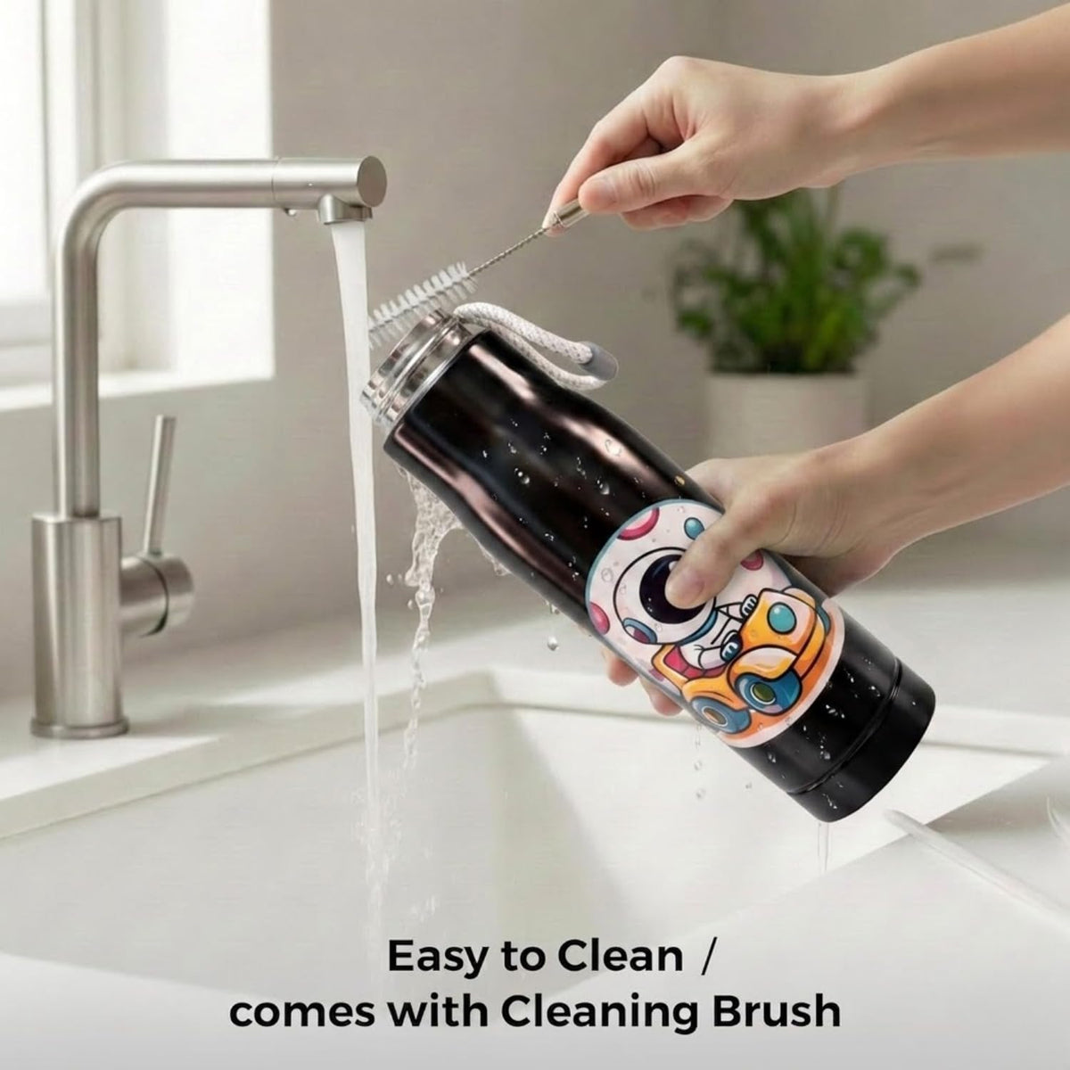 Hands cleaning the black 550ml bottle under a running tap with a brush