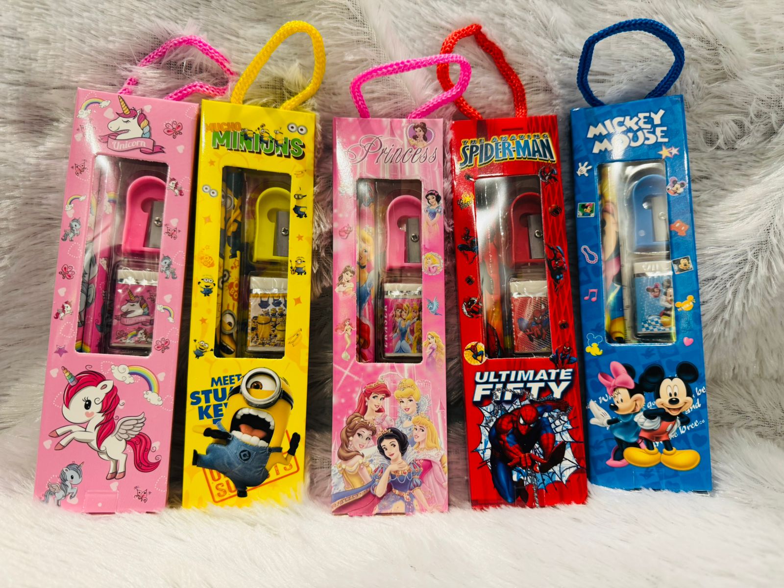 Row of character print stationery gift packs with carry cords