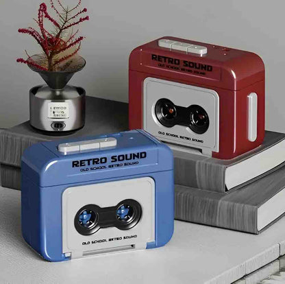 Retro cassette style mini recorder keychains in blue and dark red on books