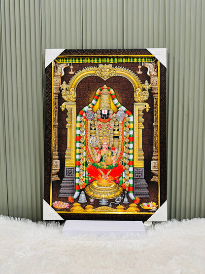 Golden framed Tirupati Balaji wall painting on a stand against a panel wall