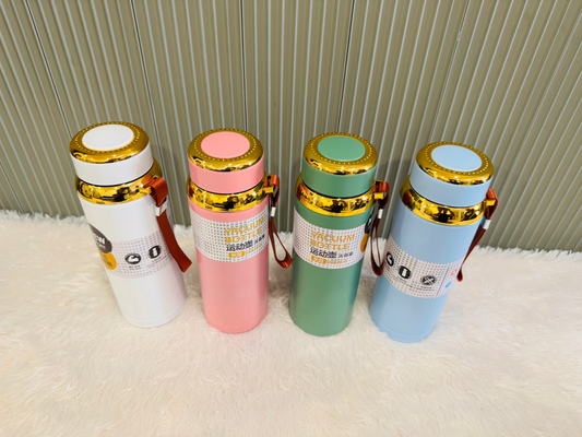 Four 800ml vacuum flasks in white, pink, green and blue on a rug