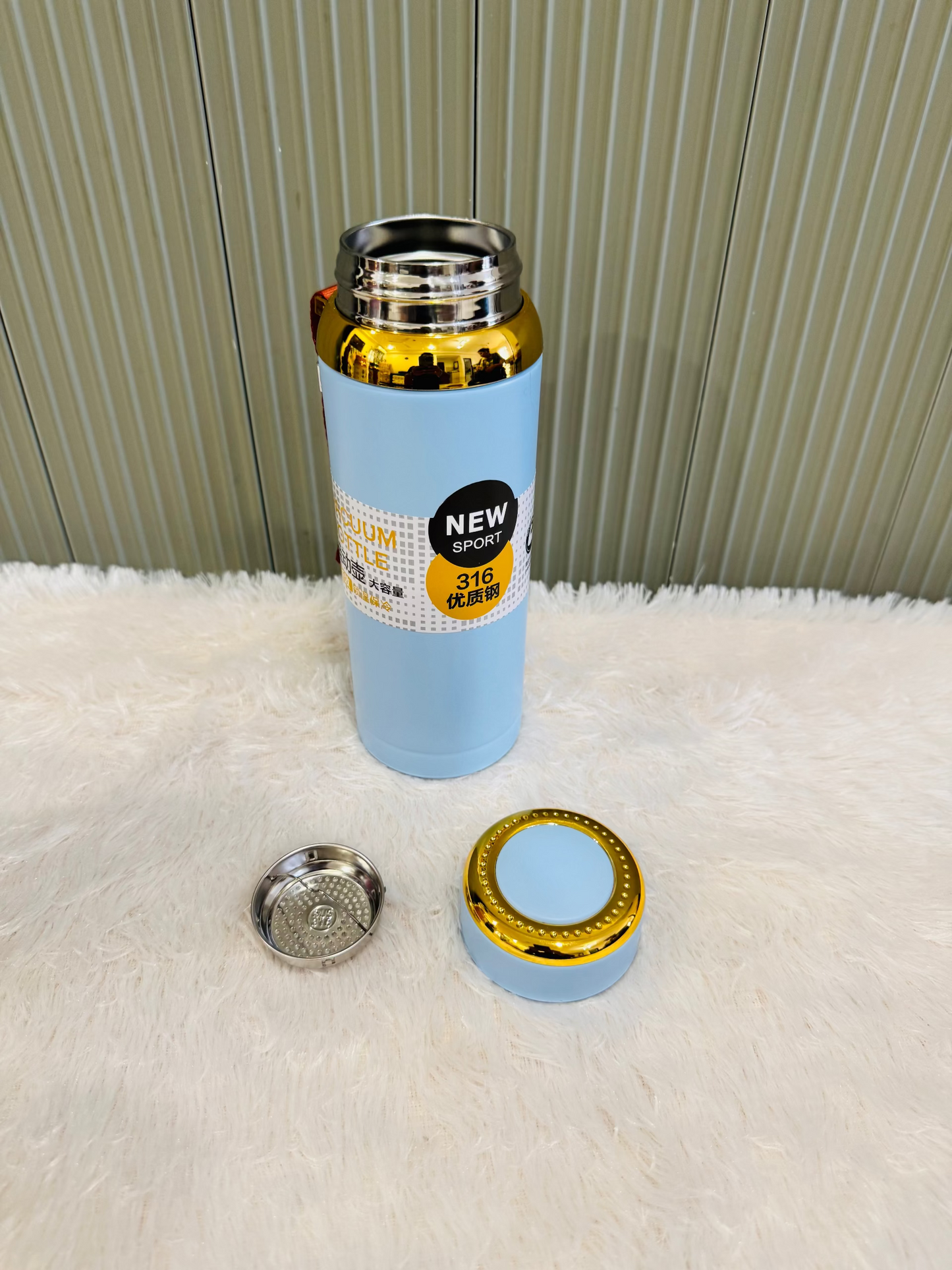 Pale blue 800ml flask beside its cup lid and steel strainer