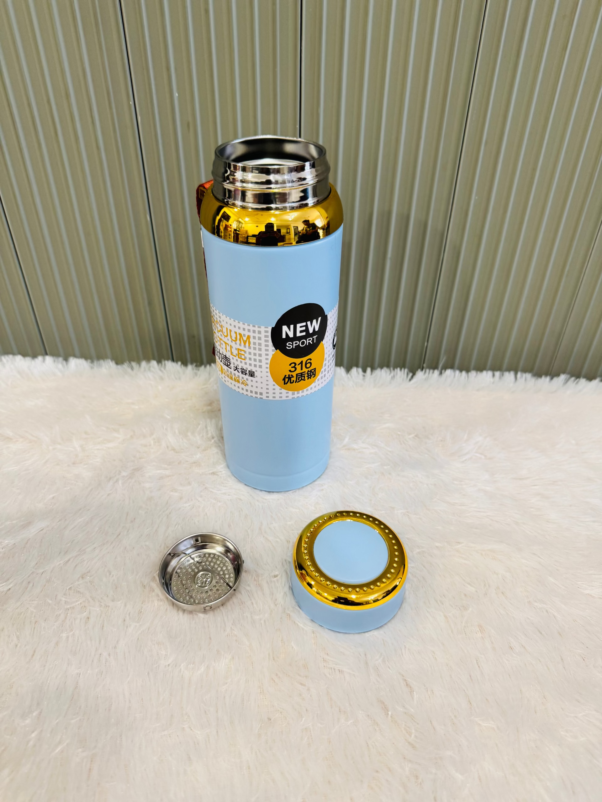 Pale blue 800ml flask beside its cup lid and steel strainer