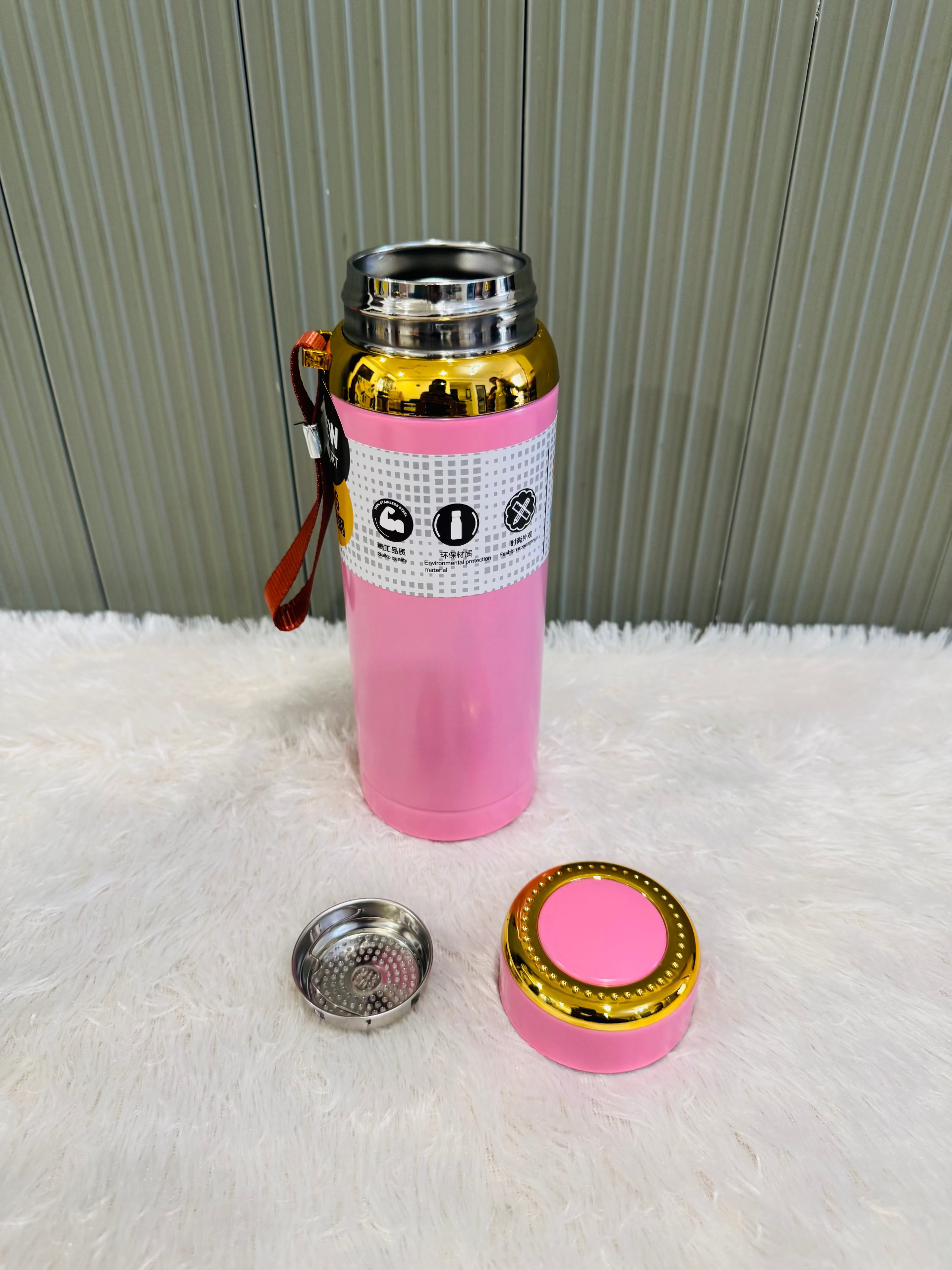 Pink 800ml flask standing beside its cup lid and steel strainer