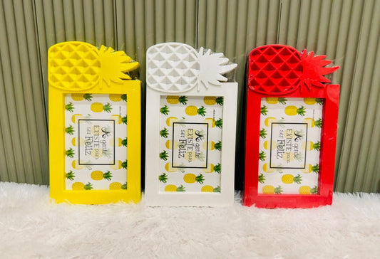 Yellow, white and red pineapple photo frames standing in a row