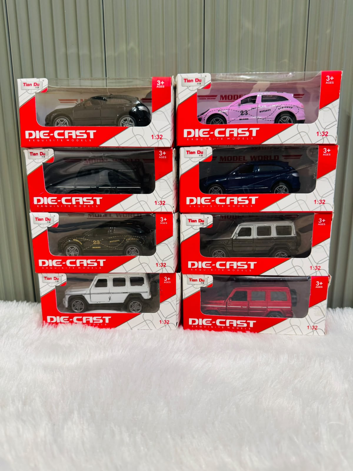 Boxed die cast toy cars in white, pink, blue, black and red