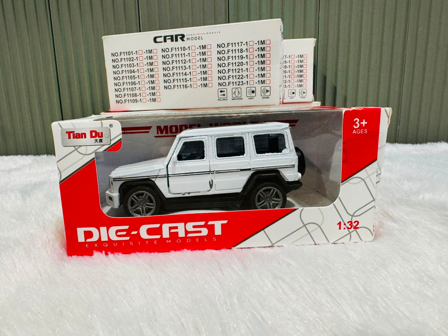 White boxed 1:32 die cast estate toy car with model list behind