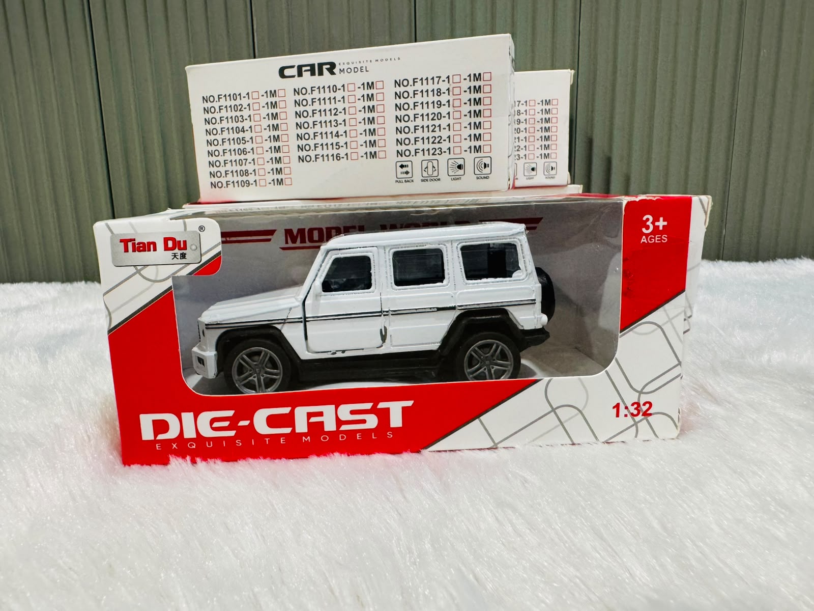 White boxed 1:32 die cast estate toy car with model list behind