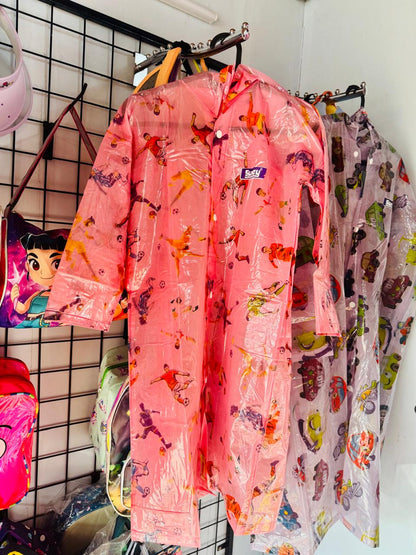 Pink cartoon print kids raincoats hanging together on a display grid