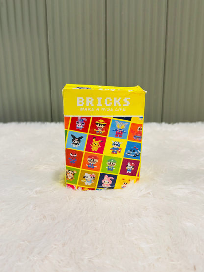 Yellow bricks block box with a colourful character grid printed on the side