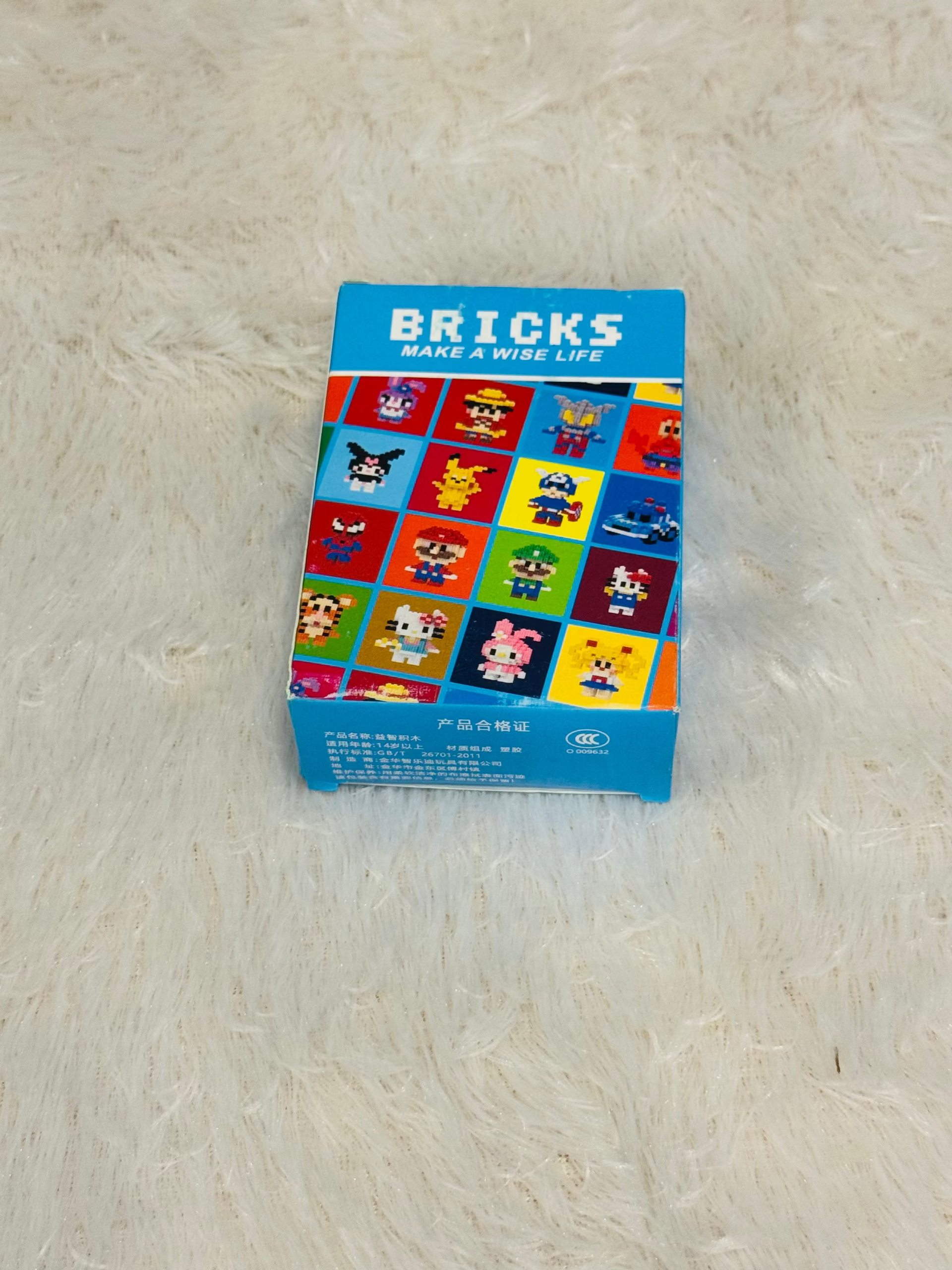 Blue bricks block box showing a printed grid of cartoon characters