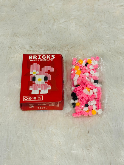 Red bricks block box beside a bag of assembled pink block figure pieces