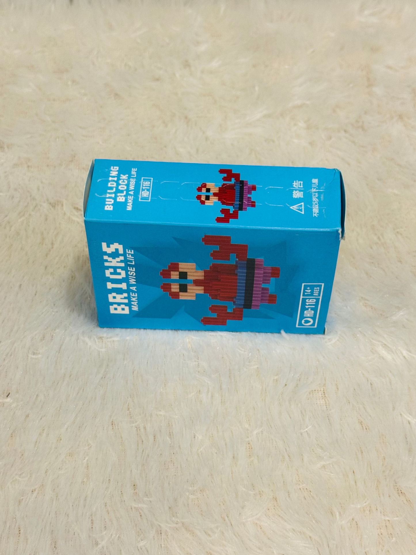 Blue bricks block box viewed from the side showing a red figure