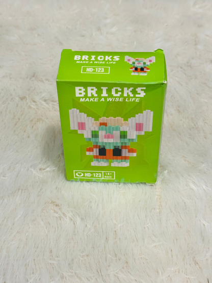 Green bricks block box standing upright on a white fluffy rug