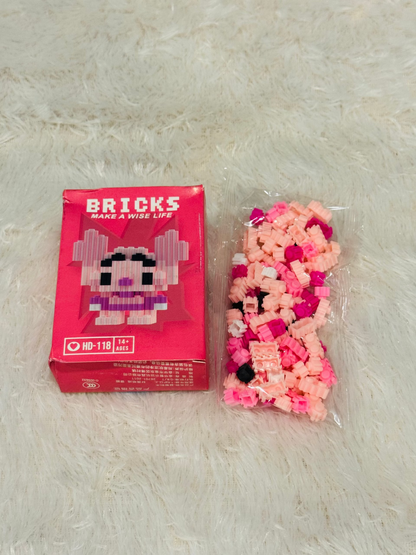Pink bricks block box beside a bag of loose pink building pieces