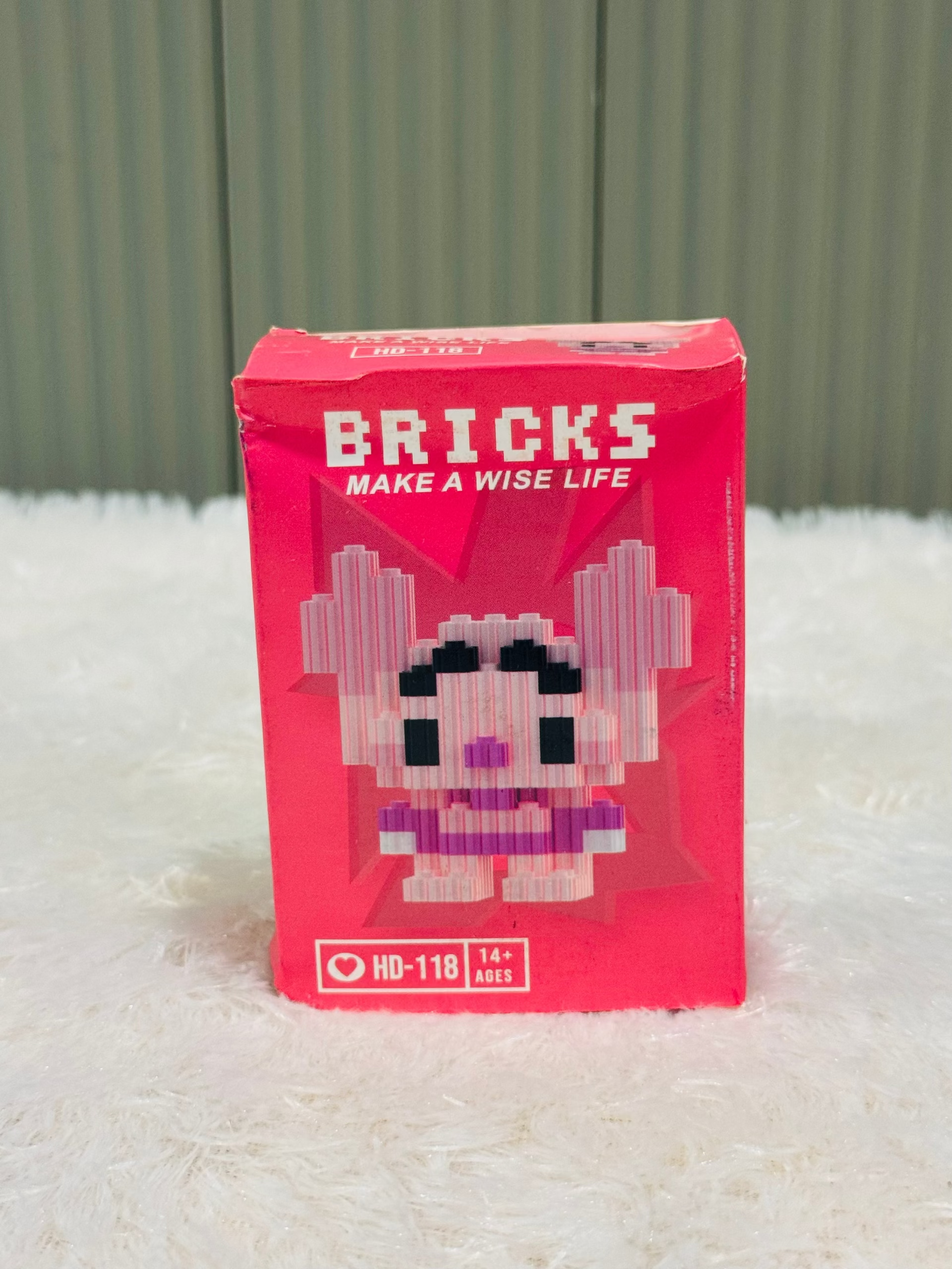 Red bricks block box showing a pink piglet style mini figure