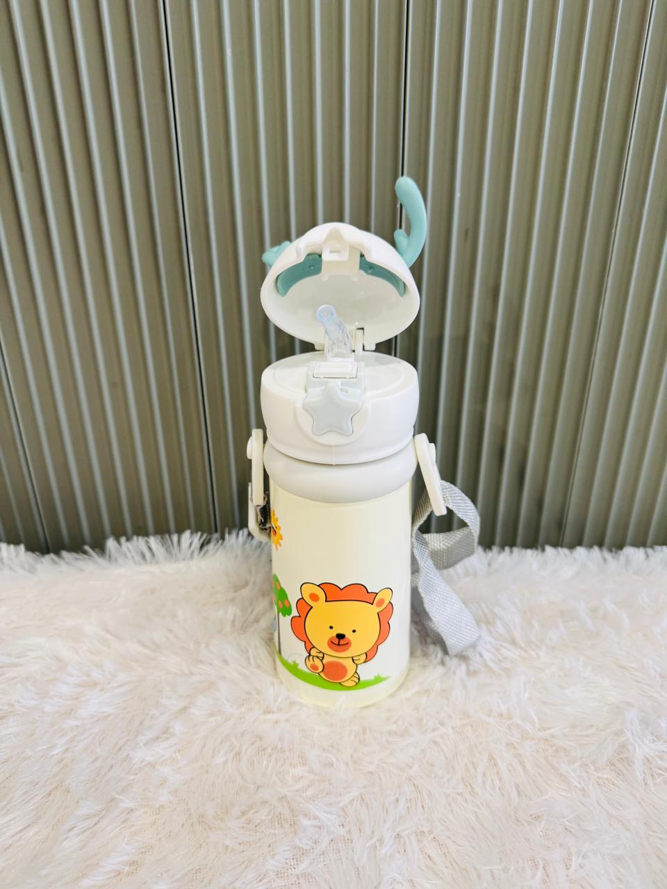 Cream reindeer bottle with lion print and flip lid open showing straw